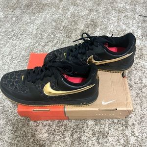 Air Force 1 black and gold sneakers